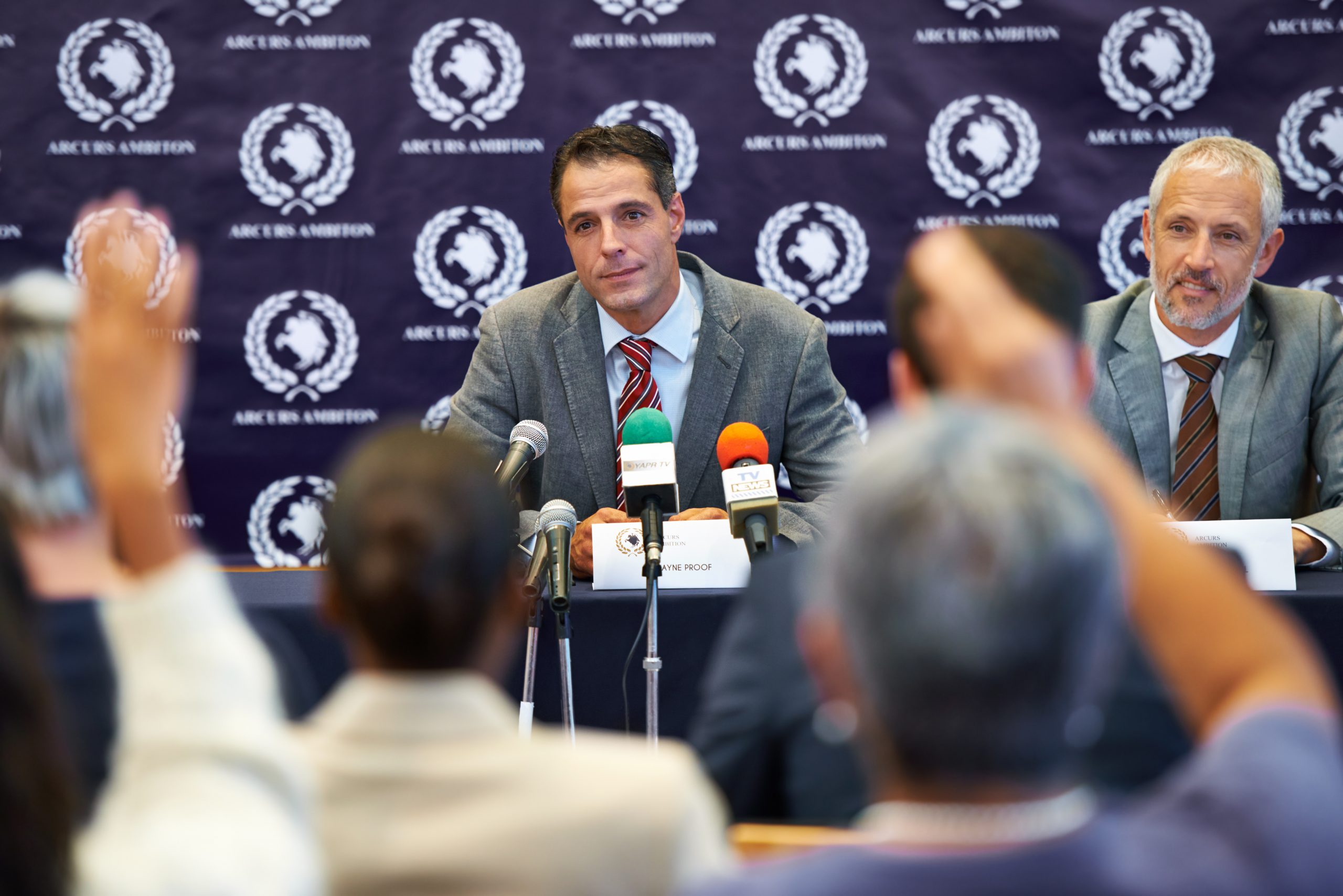 Shot of a group of businesspeople in a press conference.