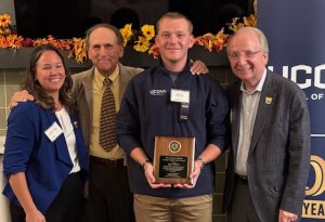 Roy Walton holding his award