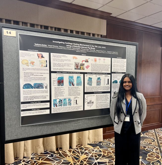 female student infront of research poster