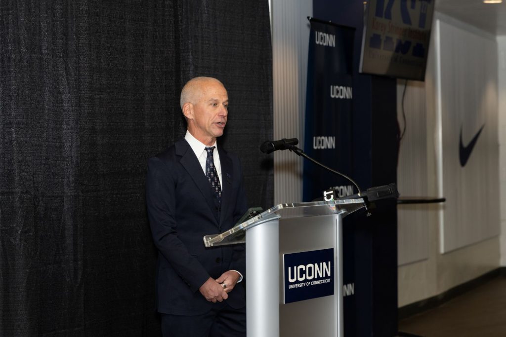 Douglas Casa speaks at the podium for the opening of the National Laboratory for Occupational Heat Safety at UConn's Korey Stringer Institute Powered by Magid & MISSION