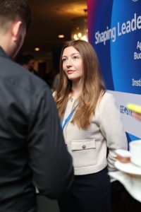 A young woman looking at another person during conversation.