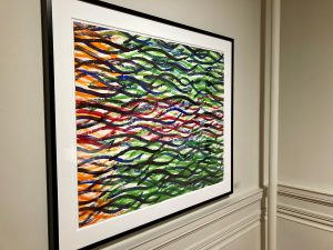 An orange, green, red, and blue watercolor painting with black squiggly lines.