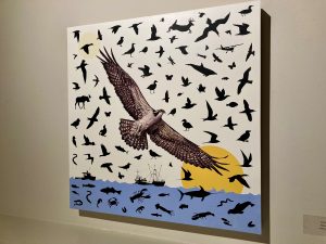 A painting of birds flying over water. Most of the birds are in silhouette, but the closest and one in focus is an osprey.