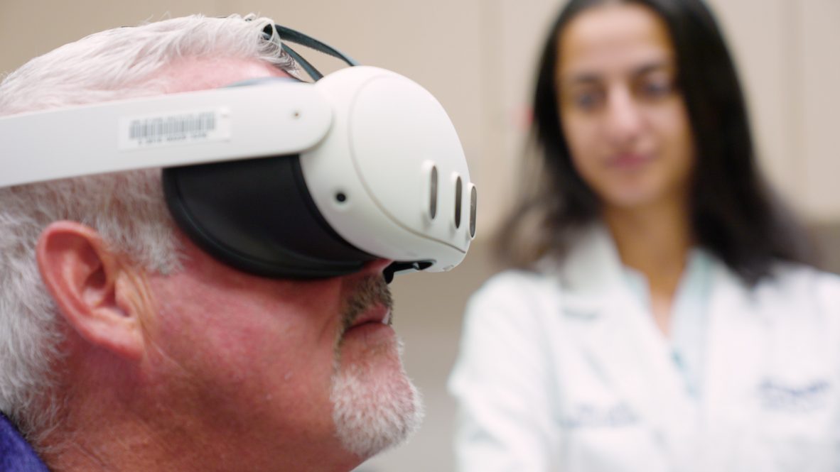 Fourth-year UConn medical student Avni Jain with a dermatology patient who is participating in a study to see if virtual reality can help reduce anxiety before a procedure. (Ryan Bernat/UConn Health)