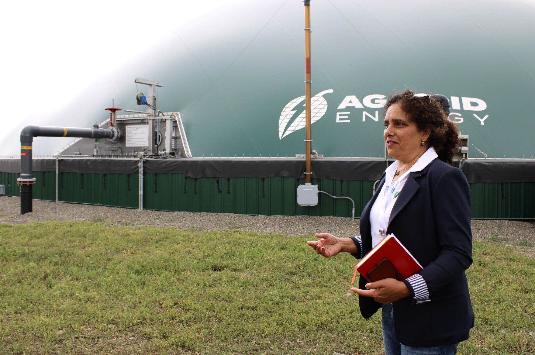 Rashi Akki in front of a large tank