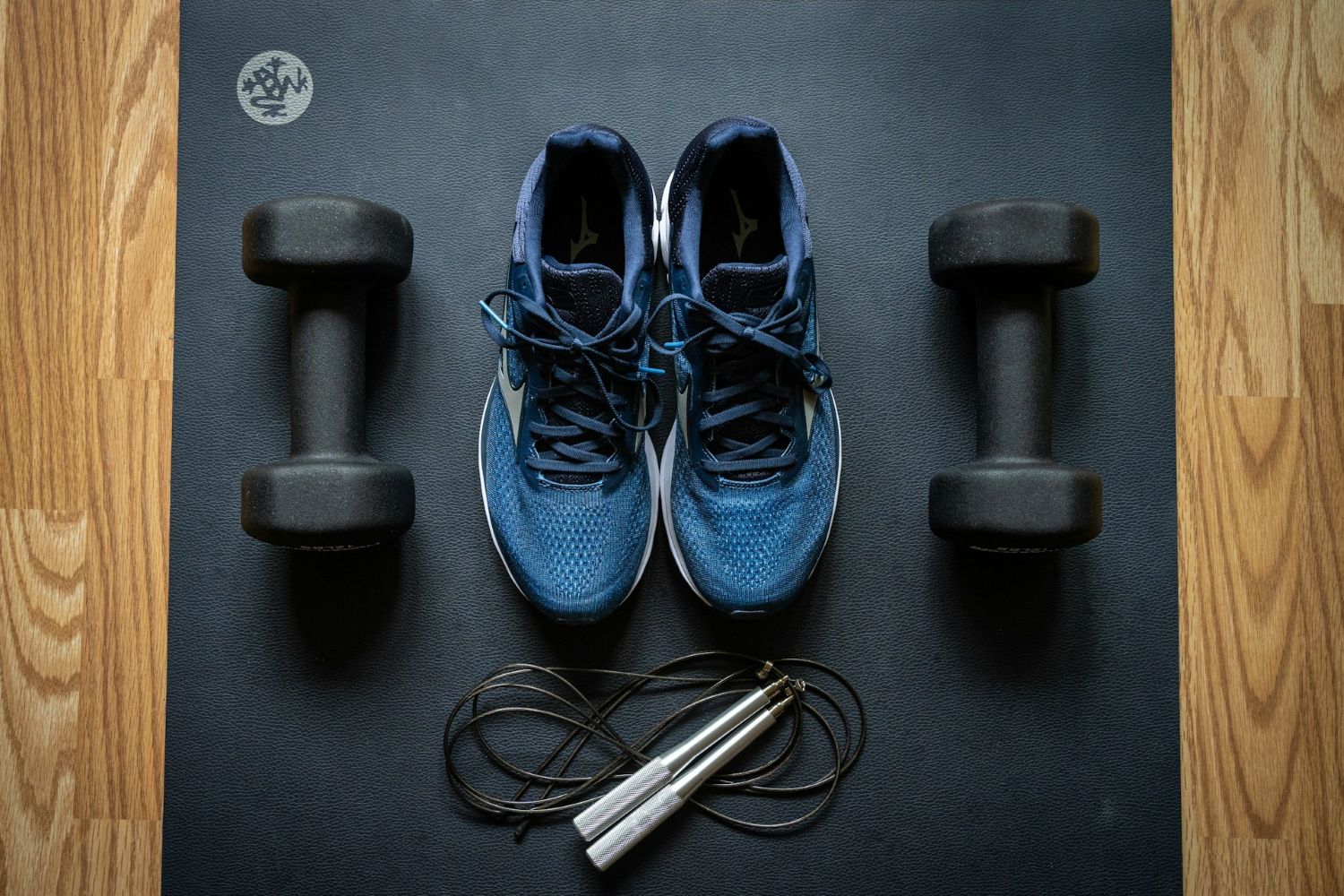 Sneakers, weights, on a gym mat