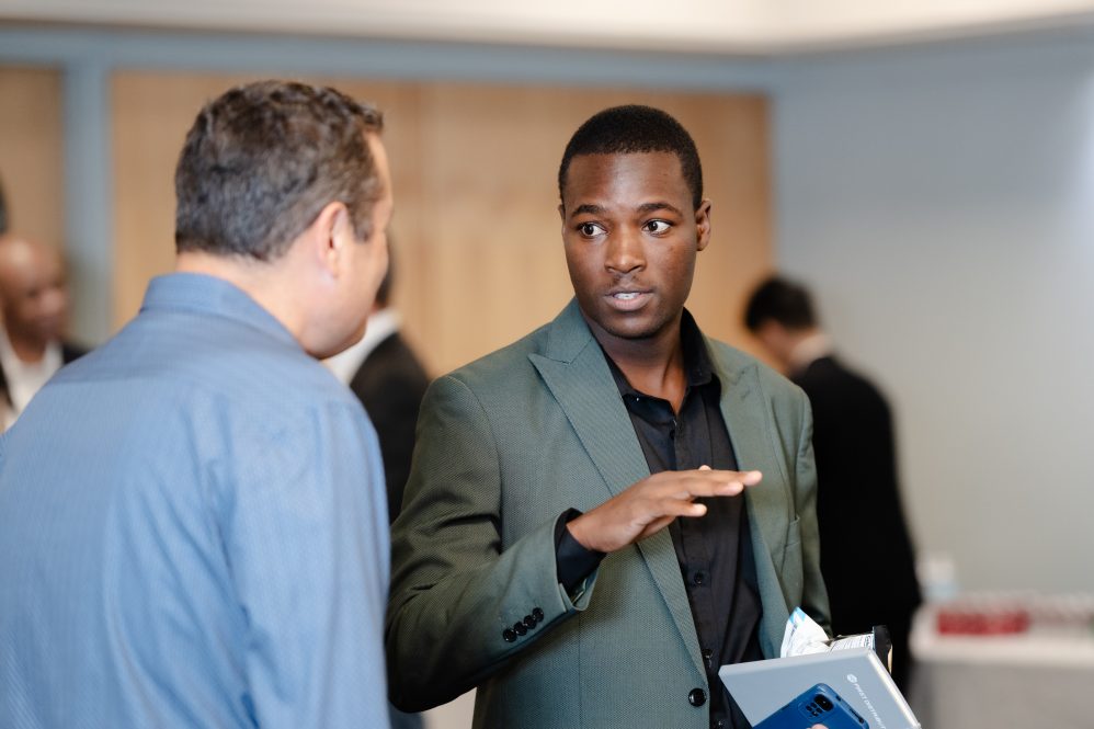 FERM graduate student Malcolm Dhikinya speaks with an Executive at UConn's Risk Manager on Campus event.