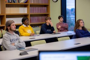 Five of the students sit in a meeting for the Historic Risk Lab.