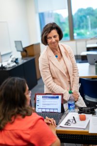 Kelly Lyman and student in a classroom.