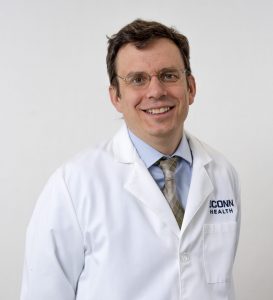 Dr. Jonathan Hargraeves in a white coat