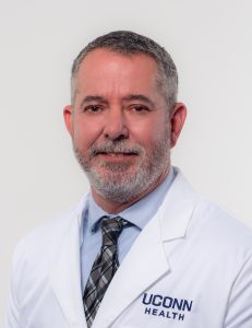 In his white coat Dr. Brett Sloan, a member of the Dermatology faculty at UConn School of Medicine