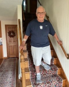 man walking down indoor staircase