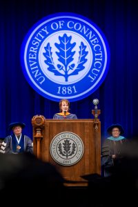 Cheryl Ficara speaking on stage at commencement. 