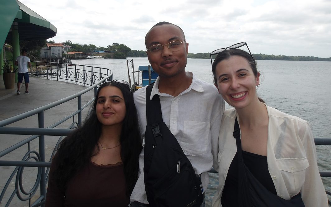 Seniors Kanika Chaturvedi and Aminieli Hopson, and graduate student Caroline Keary pose for a photo during their trip to COP 30 in Brazil.
