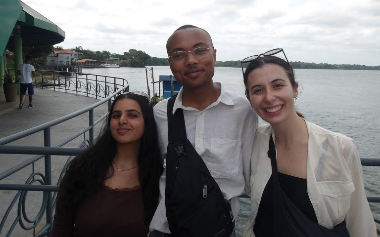 Seniors Kanika Chaturvedi and Aminieli Hopson, and graduate student Caroline Keary pose for a photo during their trip to COP 30 in Brazil.