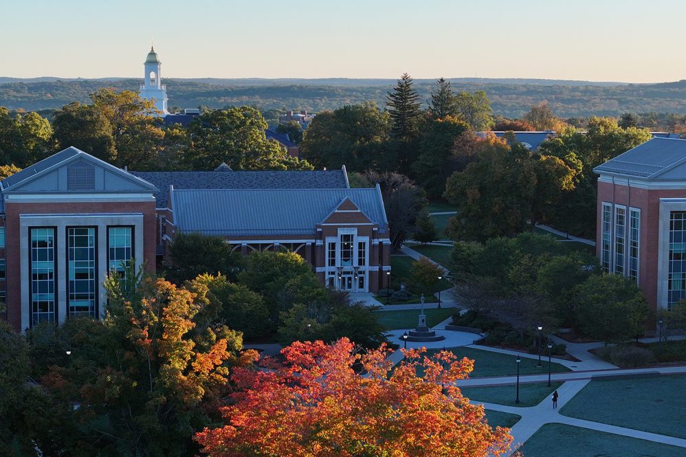 Drone shot of the center of campus during the fall with the Wilbur Cross cupola in the background