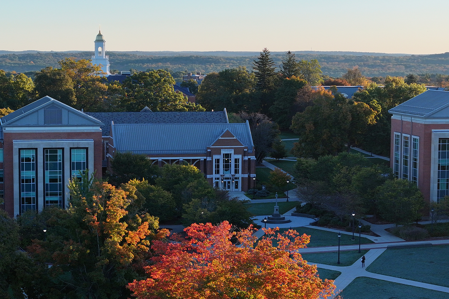 Drone shot of the center of campus during the fall with the Wilbur Cross cupola in the background
