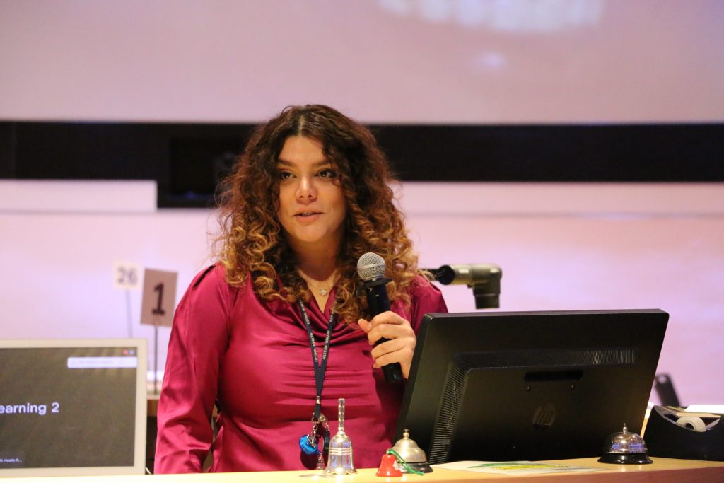 woman speaks at podium