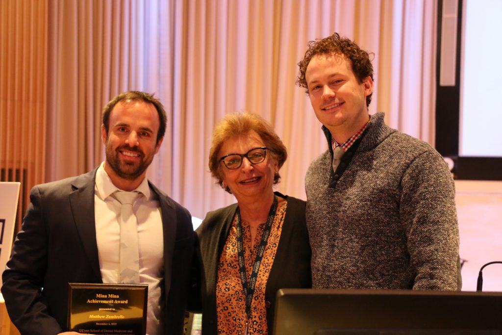 two men and one women pose