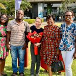 Dr. Jill Wruble poses for a welcome photo at the airport in Zambia