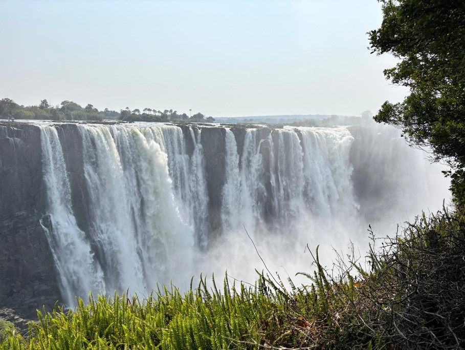 Victoria Falls in Africa water gushing on a sunny day.