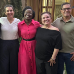 Dr. Juliet Mulopwe in bright pink dress with American experts