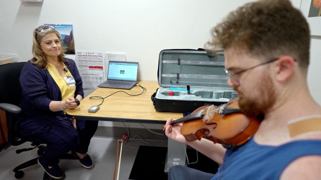 Musician and stroke patient Peter Skaar during a therapy session with Rhonda Hickey, UConn Health occupational therapist. (Ethan Giorgetti/UConn Health)