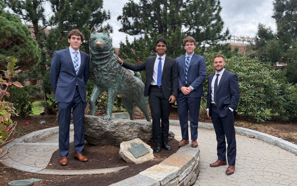 Four UConn Real Estate students: Aidan Jubb, Krishna Benzy, Grayson Glasgow and Sam Cimini., posing with the Jonathan statue in Storrs, CT