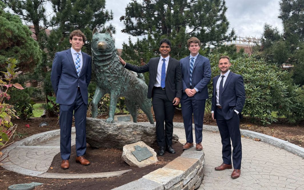 Four UConn Real Estate students: Aidan Jubb, Krishna Benzy, Grayson Glasgow and Sam Cimini., posing with the Jonathan statue in Storrs, CT