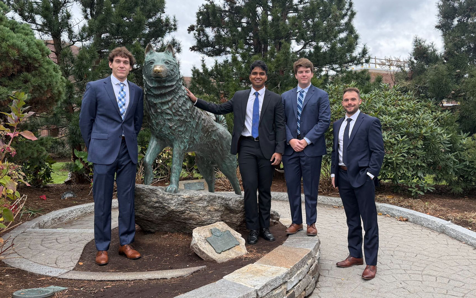 Four UConn Real Estate students: Aidan Jubb, Krishna Benzy, Grayson Glasgow and Sam Cimini., posing with the Jonathan statue in Storrs, CT