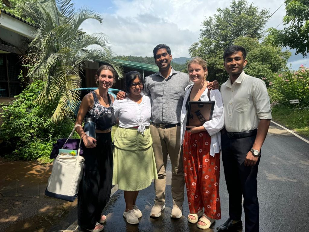 Smiling Meghan Martin (left) and Caitlin Lawrence (right) with colleagues in Sri Lanka. 