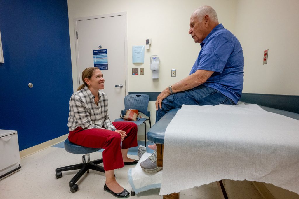 physician and patient talking in exam room