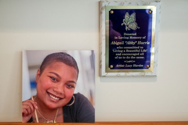 Next to a photo of Abby Harris, a plaque that says 