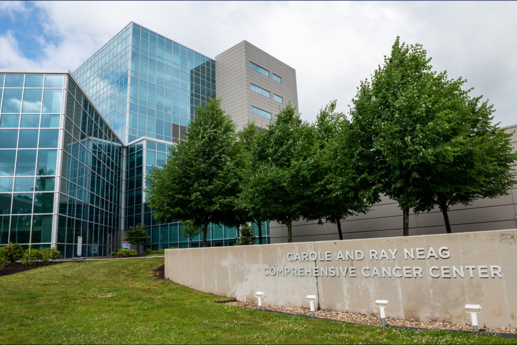 photo of building and sign that says Carole and Ray Neag Comprehensive Cancer Center