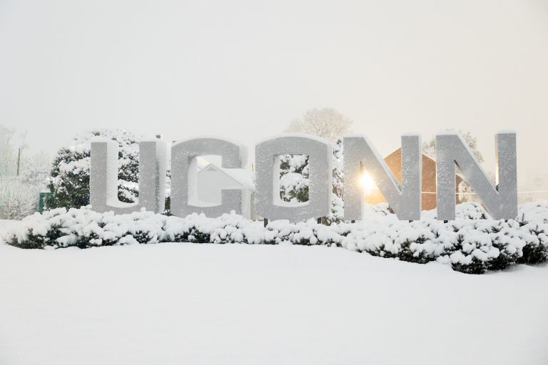 UConn gateway sign surrounded by snow