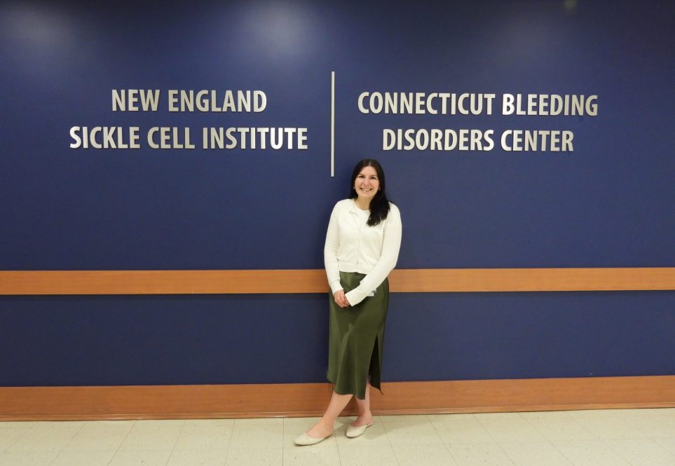 Standing in front of new signage for Institute is Ali Serrantino.