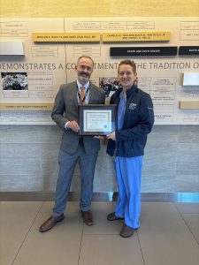 Two men standing together with a plaque.