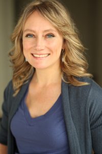 A headshot photo of a smiling woman