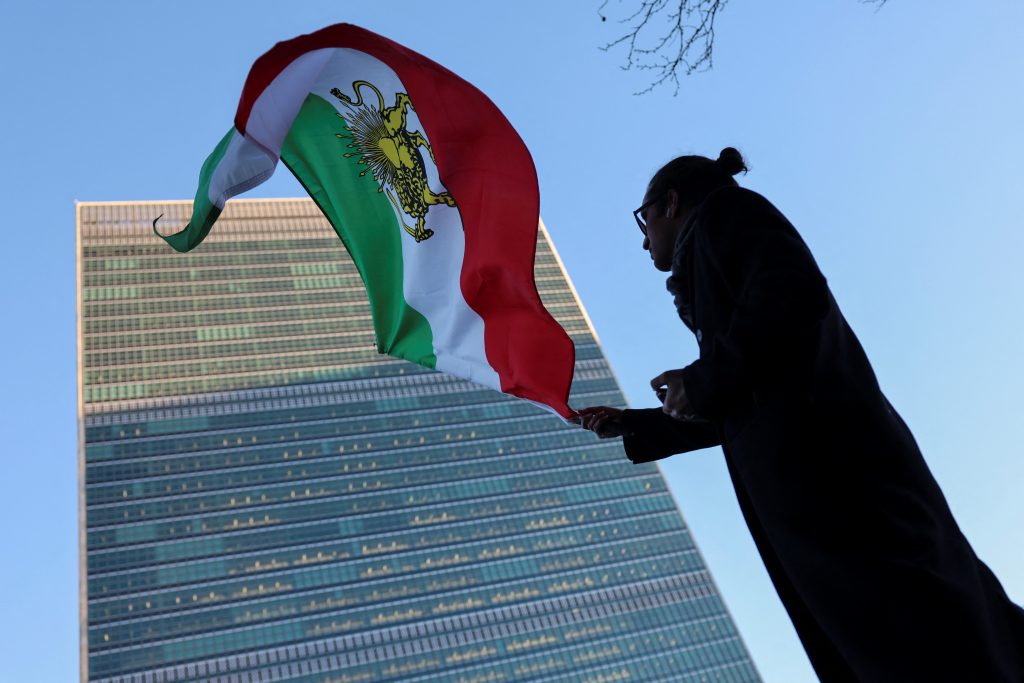 A protester waves the pre-Islamic Revolution Iranian flag outside UN headquarters.