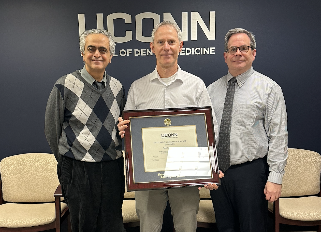 three dentists with award