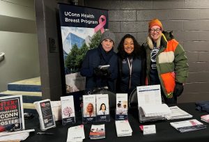 a man and two women stand behind a table