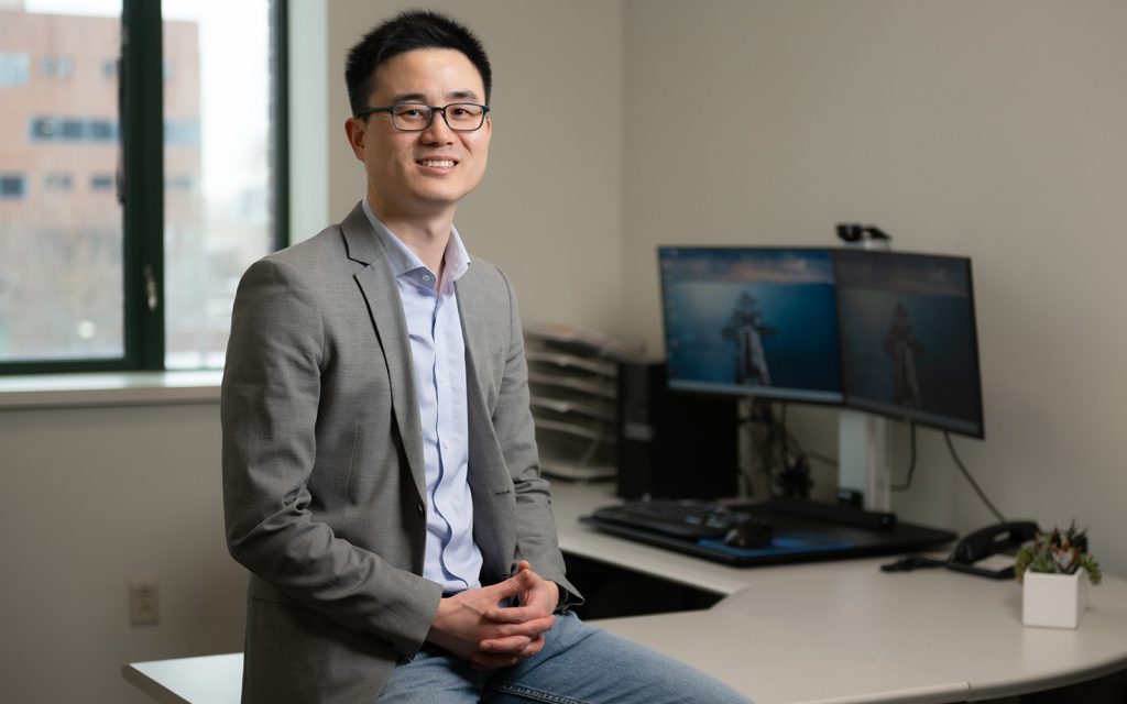 OPIM Professor Jing Peng, in his office in Storrs, CT (Nathan Oldham / UConn School of Business)