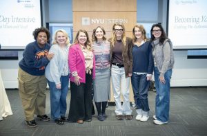 A group of seven people in front of an 