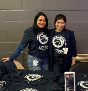 two women standing together smiling