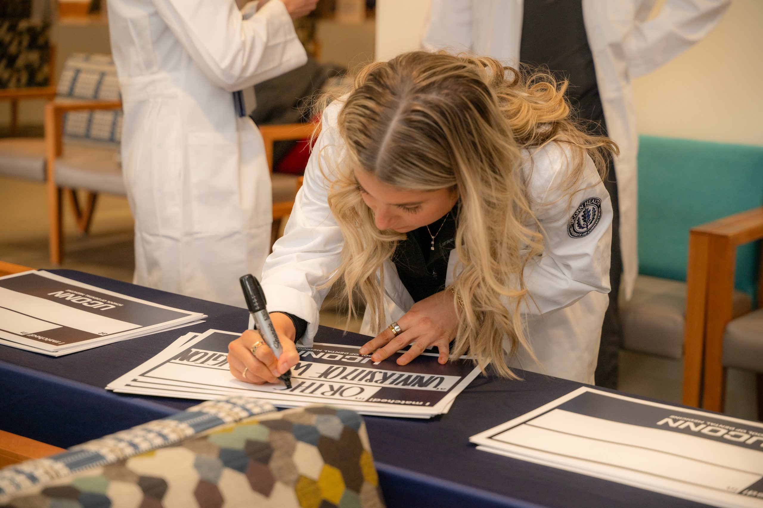 student writes on sign