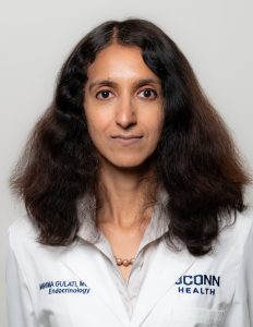 Head shot of Dr. Mahima Gulati, woman in her white coat