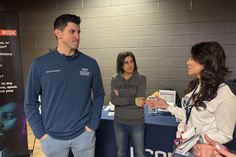 man talking to two women