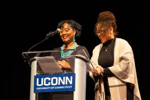 Two women standing together at a podium.