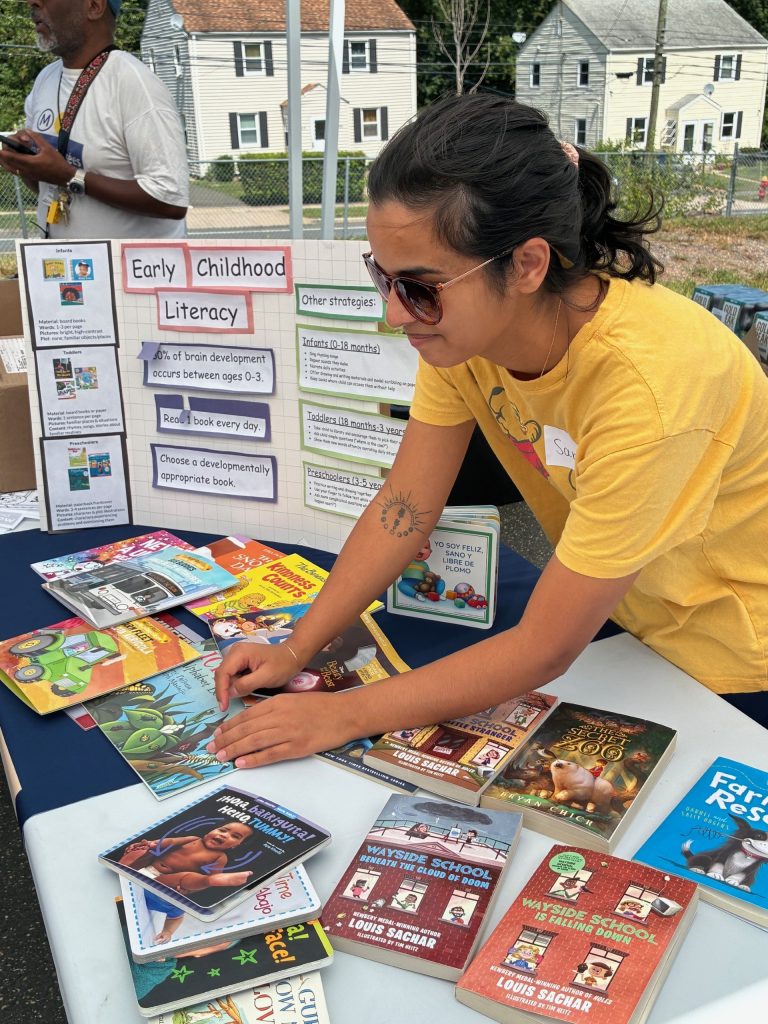 Student at info booth in community.