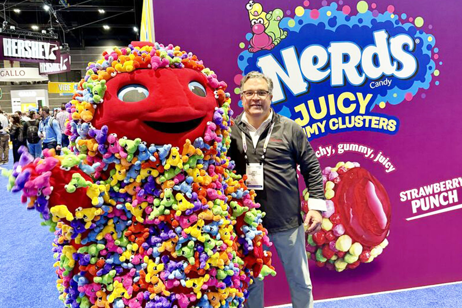 Guidotti poses next to Nerds Gummy Clusters mascot.
